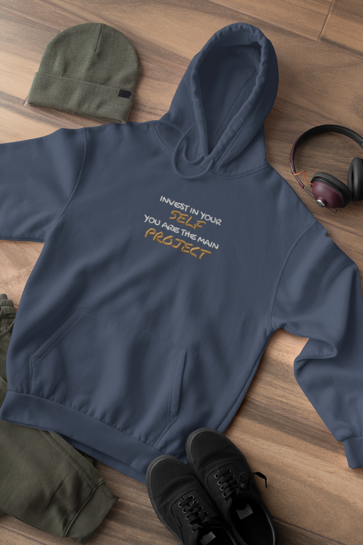 "INVEST IN YOURSELF YOU ARE THE MAIN PROJECT." Design With Gold White Embroidered Text. Classic Unisex Pullover Hoodie Premium Quality Original Clothing. Wear Your Motivation.