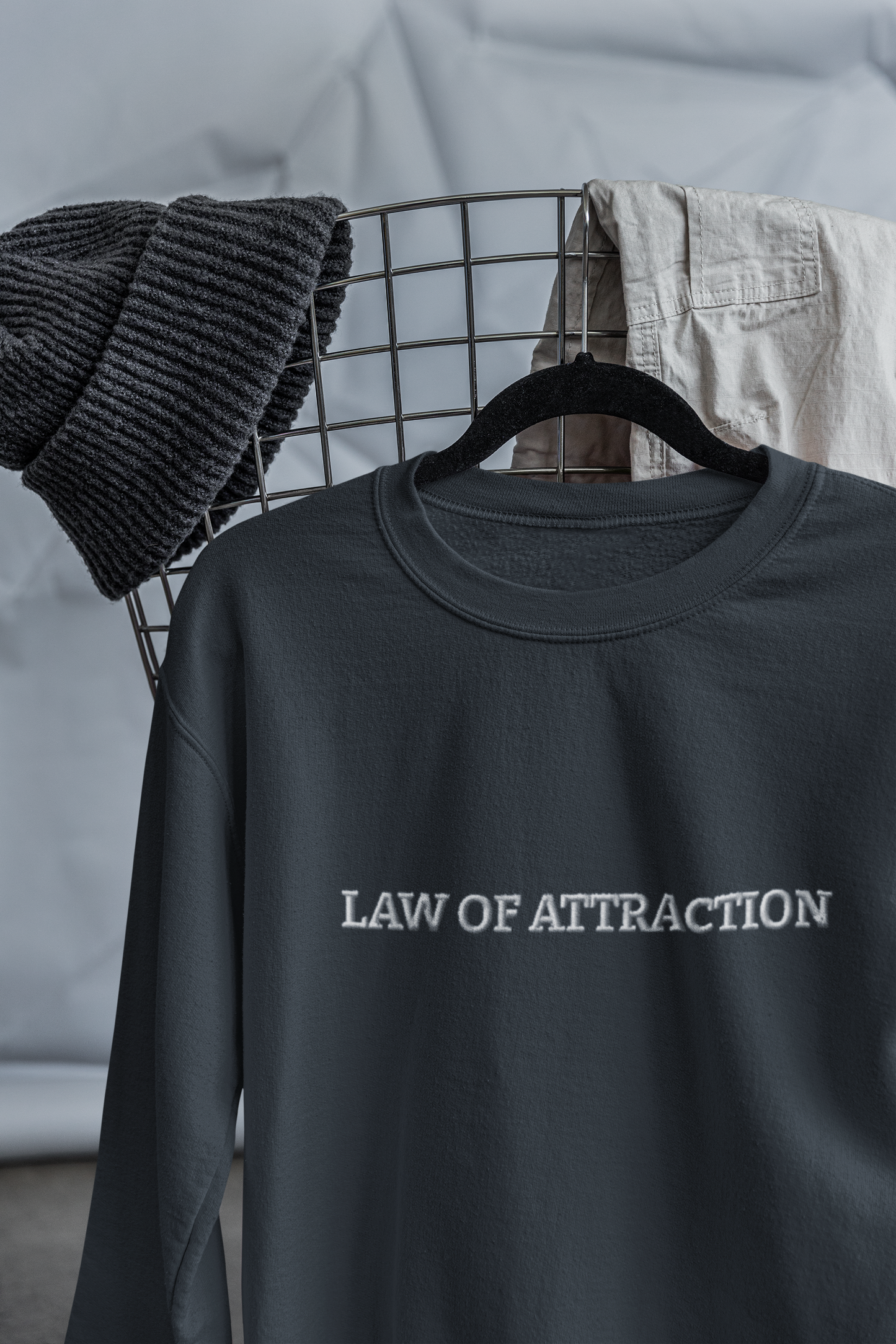 "LAW OF ATTRACTION" Design With White Embroidered Text. Classic Unisex Crewneck Sweatshirt Premium Quality Original Clothing. Wear Your Motivation