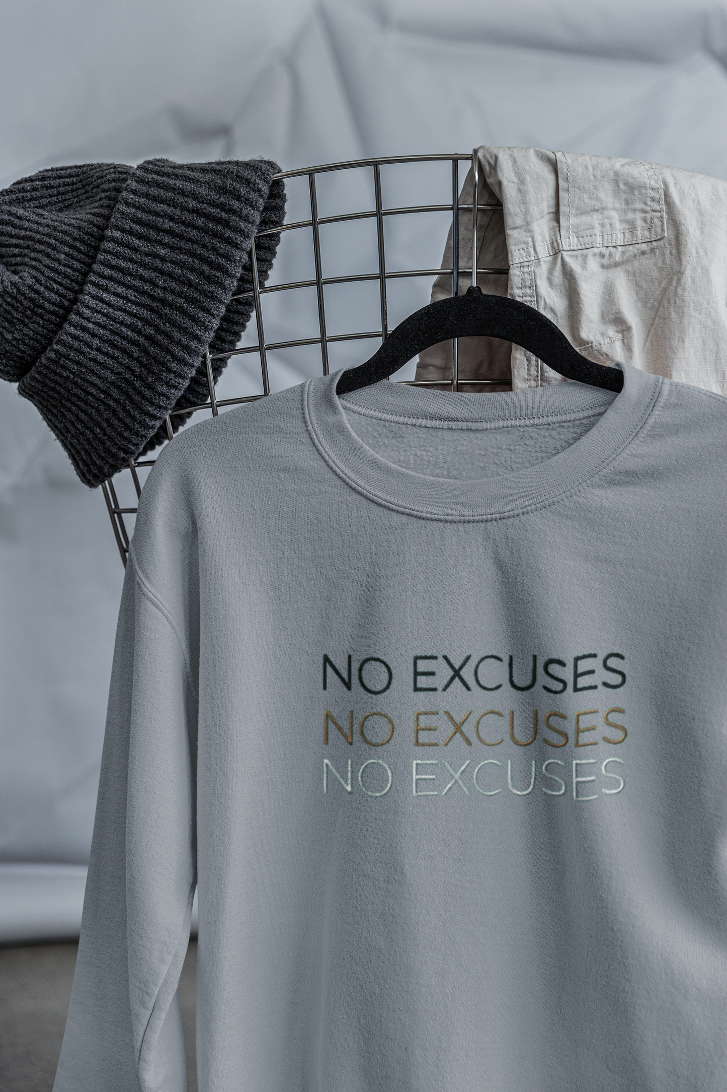 "NO EXCUSES" Design With Gold Black White Embroidered Text. Classic Unisex Crewneck Sweatshirt Premium Quality Original Clothing. Wear Your Motivation.