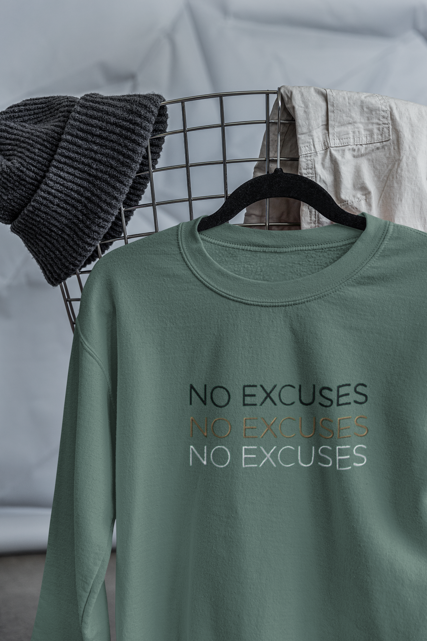 "NO EXCUSES" Design With Gold Black White Embroidered Text. Classic Unisex Crewneck Sweatshirt Premium Quality Original Clothing. Wear Your Motivation.