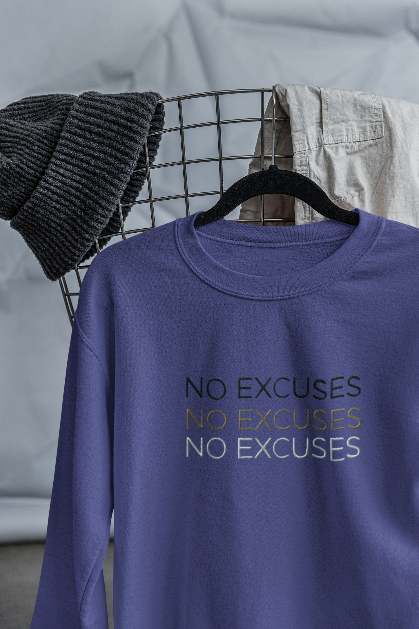 "NO EXCUSES" Design With Gold Black White Embroidered Text. Classic Unisex Crewneck Sweatshirt Premium Quality Original Clothing. Wear Your Motivation.