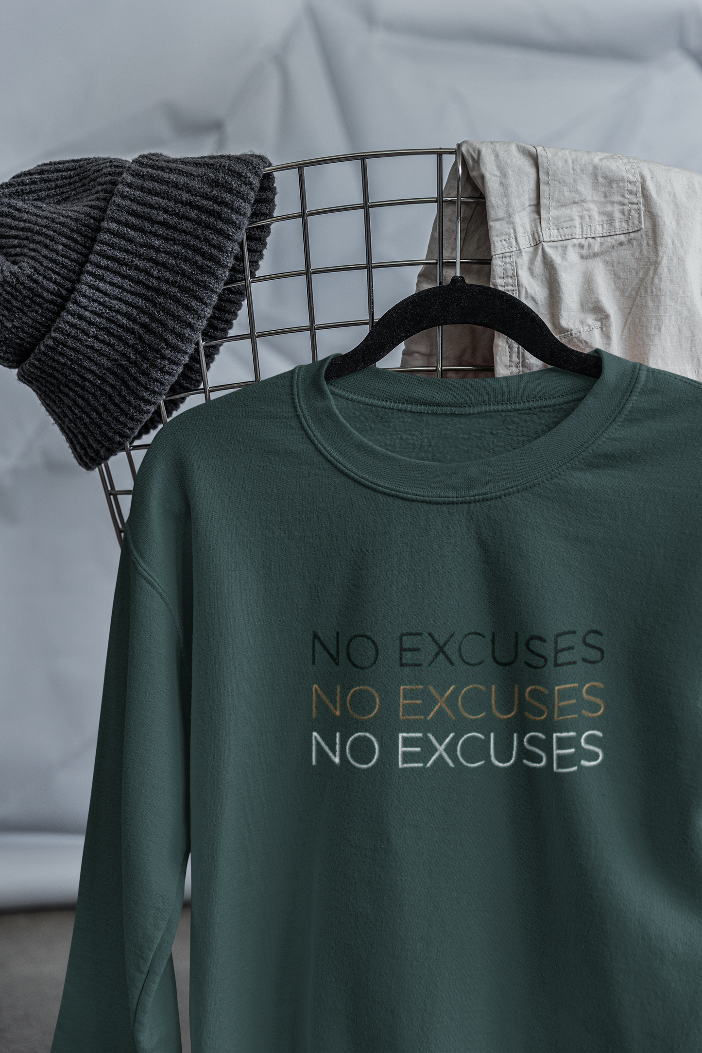 "NO EXCUSES" Design With Gold Black White Embroidered Text. Classic Unisex Crewneck Sweatshirt Premium Quality Original Clothing. Wear Your Motivation.