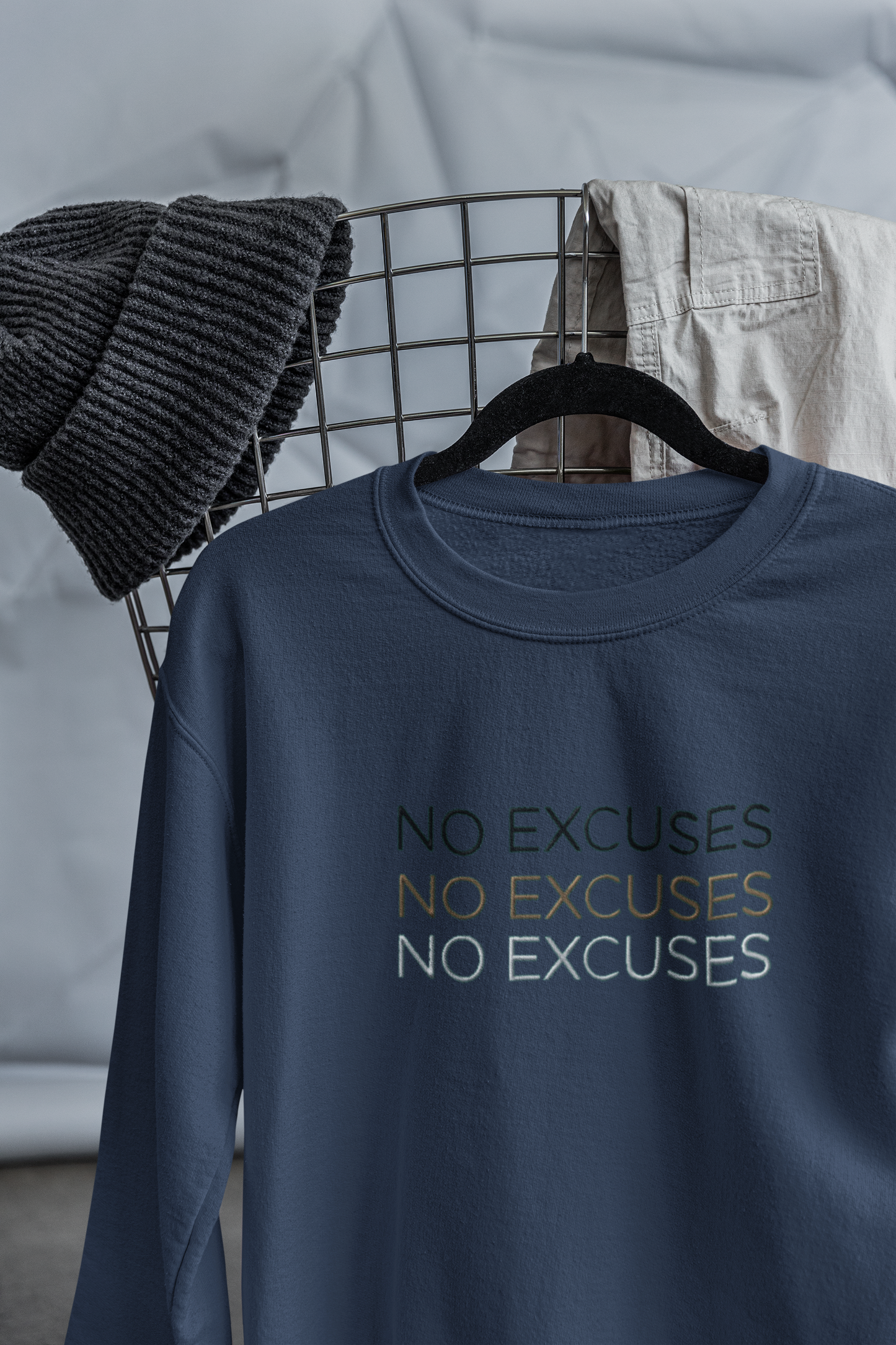 "NO EXCUSES" Design With Gold Black White Embroidered Text. Classic Unisex Crewneck Sweatshirt Premium Quality Original Clothing. Wear Your Motivation.