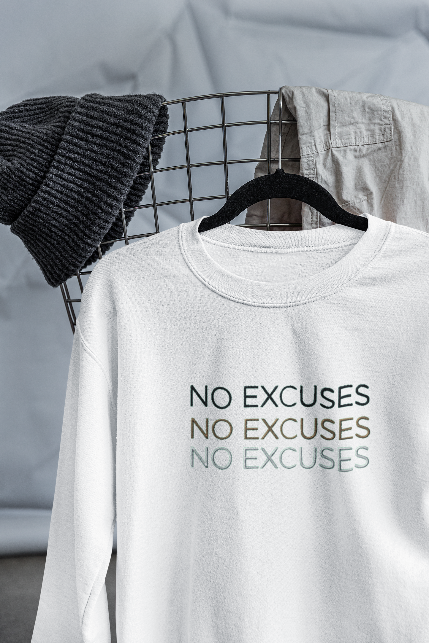 "NO EXCUSES" Design With Gold Black White Embroidered Text. Classic Unisex Crewneck Sweatshirt Premium Quality Original Clothing. Wear Your Motivation.