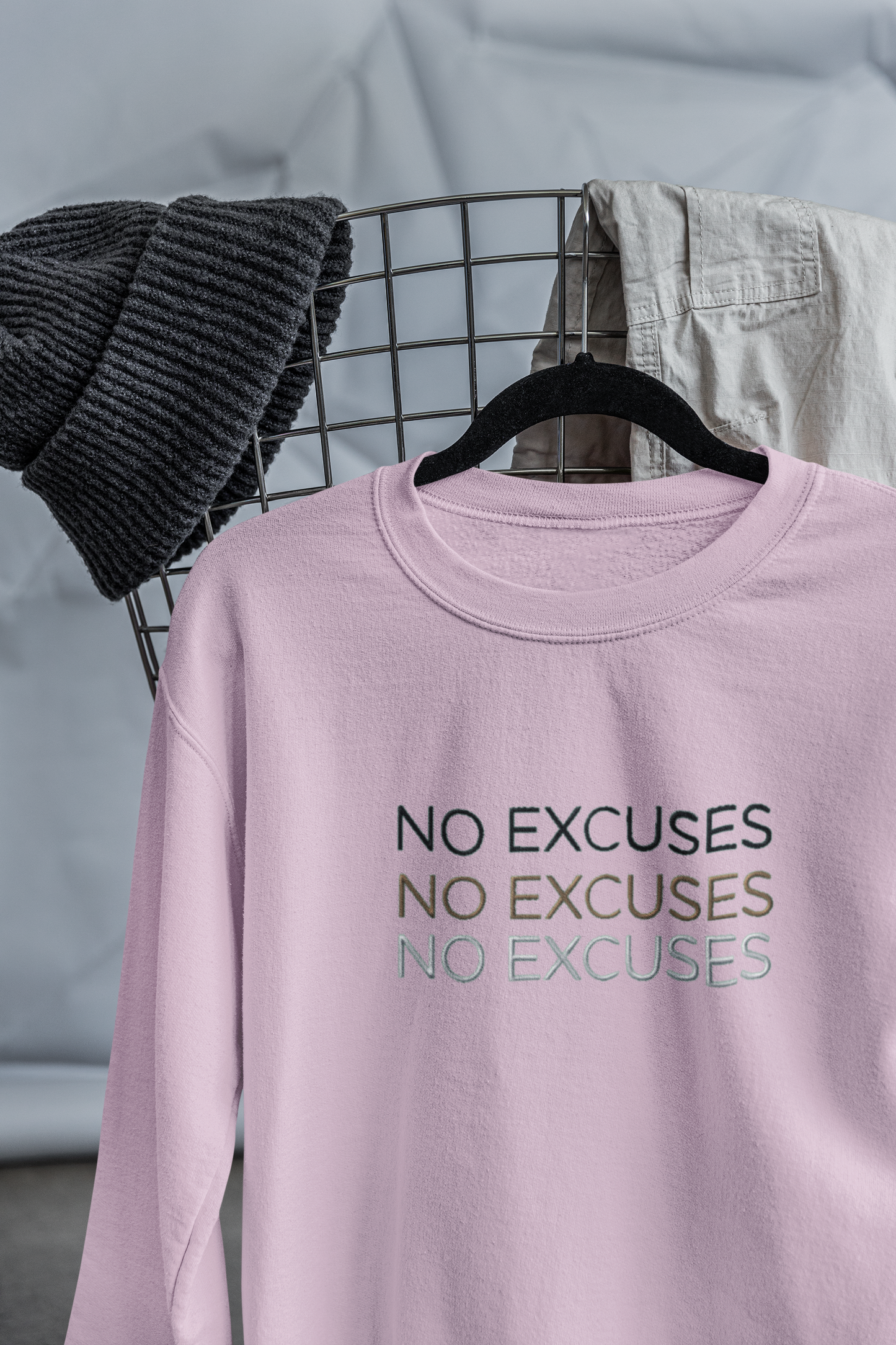 "NO EXCUSES" Design With Gold Black White Embroidered Text. Classic Unisex Crewneck Sweatshirt Premium Quality Original Clothing. Wear Your Motivation.