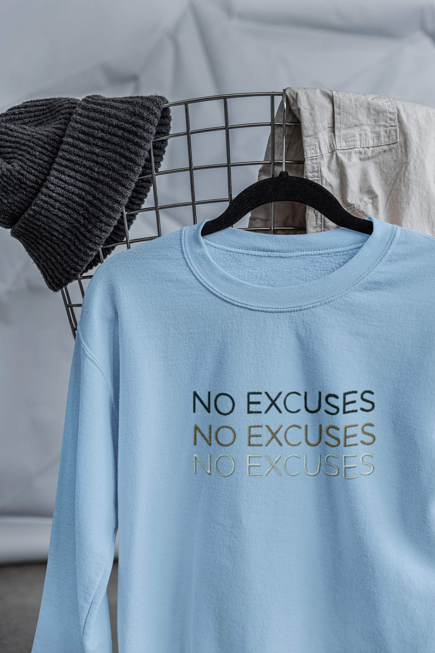 "NO EXCUSES" Design With Gold Black White Embroidered Text. Classic Unisex Crewneck Sweatshirt Premium Quality Original Clothing. Wear Your Motivation.